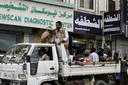 People ride on the back of a truck taxi in Yemen's capital Sanaa May 6, 2015. REUTERS/Khaled Abdullah