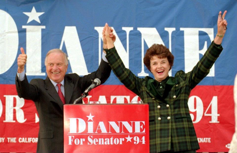 Mayor Richard Riordan clasps raised hands with Dianne Feinstein