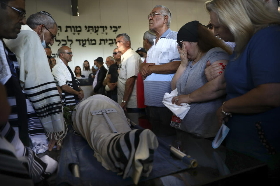Mourners attend the funeral of Yigal Yehoshua, 56, at a cemetery in Hadid, central Israel, Tuesday, May 18, 2021. Yehoshua died of wounds sustained when his car was pelted with rocks during Israeli Arab riots in the Israeli city of Lod on May 11. (AP Photo/Oded Balilty)