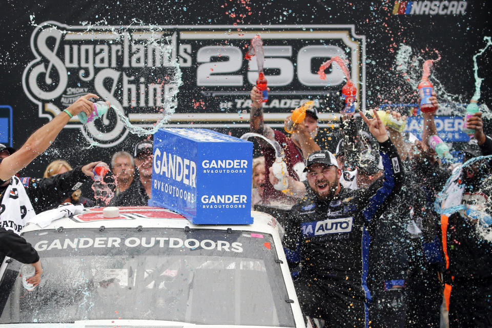 Camping World Truck Series driver Spencer Boyd (20) celebrates in Victory Lane after being declared the winner as driver Johnny Sauter (13) was disqualified during the Sugarlands Shine 250 at Talladega Superspeedway, Saturday, Oct 12, 2019, in Talladega, Ala. (AP Photo/Butch Dill)