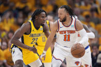 New York Knicks guard Jalen Brunson (11) drives around Indiana Pacers forward Aaron Nesmith (23) during the second half of Game 6 in an NBA basketball second-round playoff series, Friday, May 17, 2024, in Indianapolis. (AP Photo/Michael Conroy)