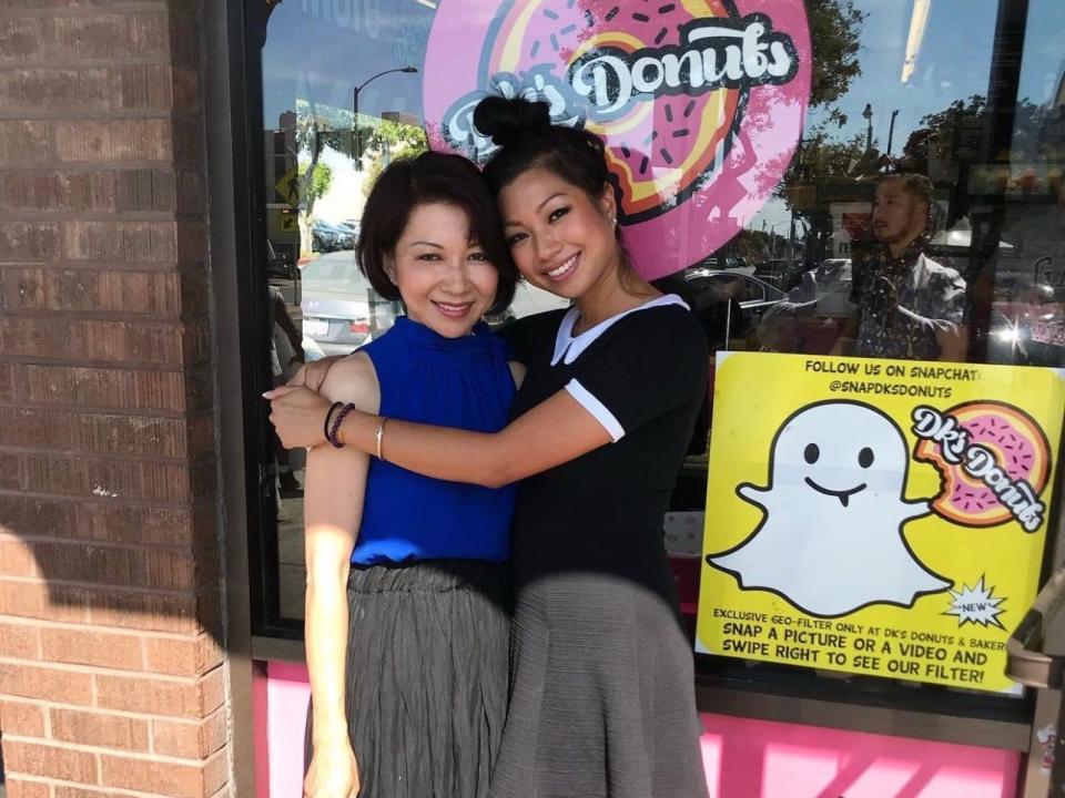 Mother and daughter Chuong Lee and Mayly Tao stand in front of their family doughnut shop, DK's Donuts & Bakery.