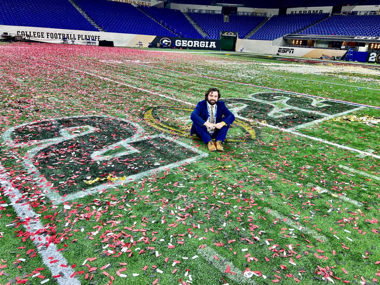 McClain Baxley poses on the field at Lucas Oil Stadium in Indianapolis after the 2022 National Championship.