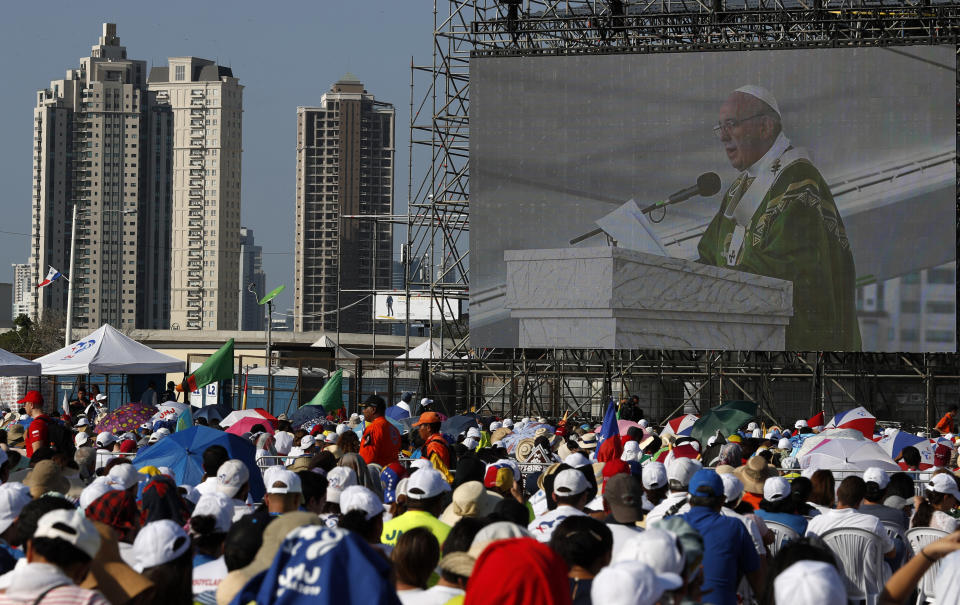 Youth watch Pope Francis displayed on a large screen during an early morning Mass at the metro park Campo San Juan Pablo II in Panama City, Sunday, Jan. 27, 2019. The Mass marks the formal end to World Youth Day, the once-every-three year religious festival that John Paul launched during his quarter-century pontificate. (AP Photo/Rebecca Blackwell)