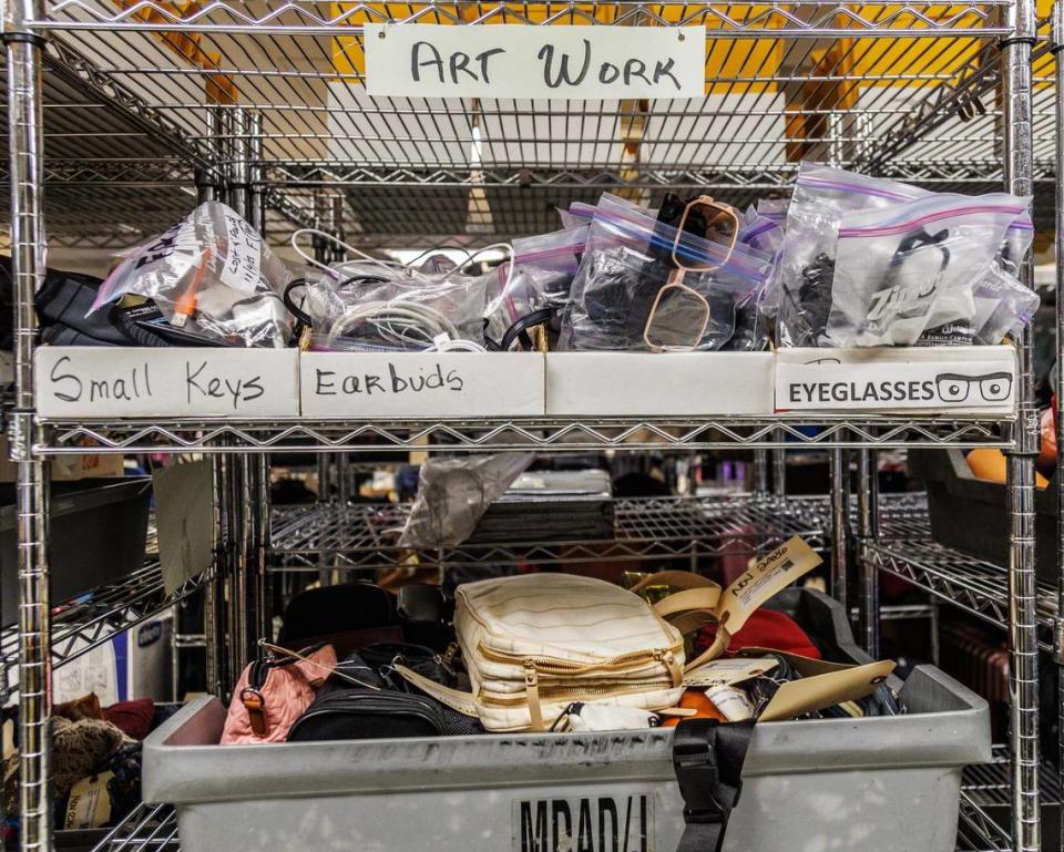 View of a shelf with a variety of items left behind by passengers, stored at the Lost and Found department at Miami International Airport, till owners claim them, on Tuesday December 13, 2023.