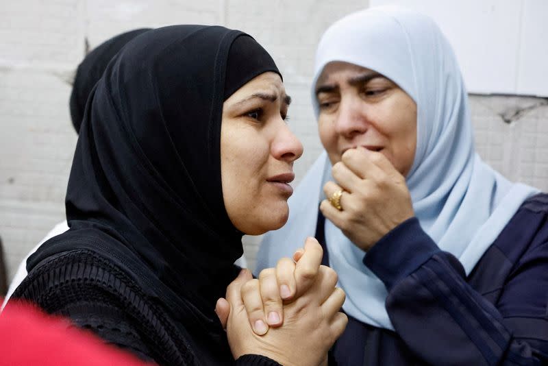 Mourners react next to bodies of Palestinians who were killed in an Israeli raid, in Tulkarm