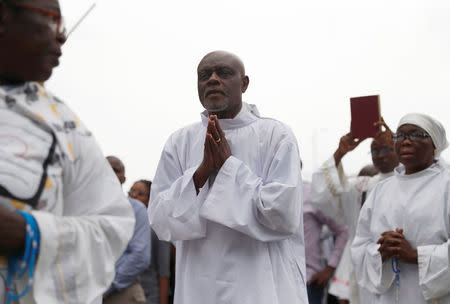 A priest prays outside Notre Dame Cathedral in Kinshasa, Democratic Republic of Congo, February 25, 2018. REUTERS/Goran Tomasevic