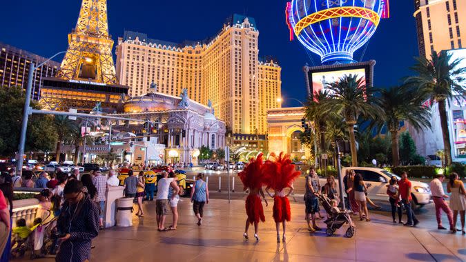 Las Vegas, Nevada, USA - June 7, 2014: Night time street view of the Las Vegas Strip in Nevada with car traffic and people strolling around.