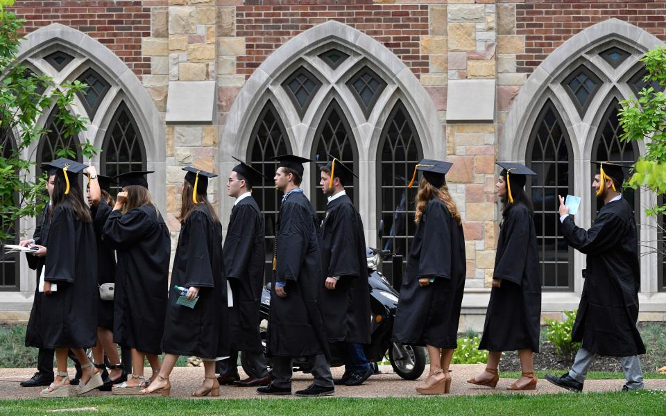 Graduates walk to their starting place before Vanderbilt University graduation Friday, May 10, 2019, in Nashville, Tenn. 