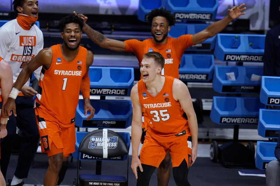 Syracuse's Quincy Guerrier (1), Buddy Boeheim (35) and Alan Griffin celebrate a teammate's 3-point shot late in the second half against San Diego State in a college basketball game in the first round of the NCAA men's tournament at Hinkle Fieldhouse in Indianapolis, Friday, March 19, 2021. (AP Photo/AJ Mast)