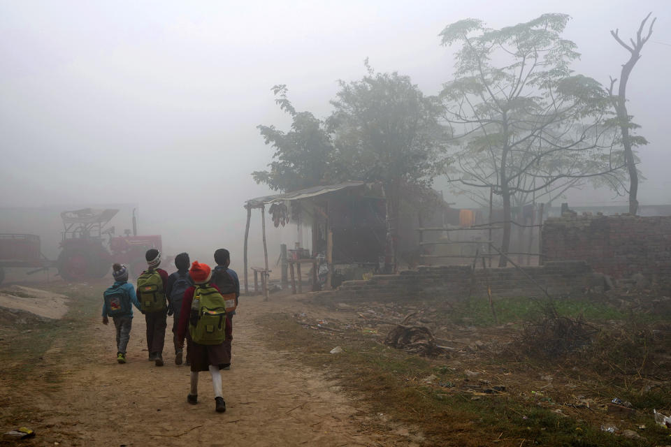 Children walk to school in Raebareli district of Uttar Pradesh, India, Dec. 20, 2022.<span class="copyright">Rajesh Kumar Singh—AP</span>