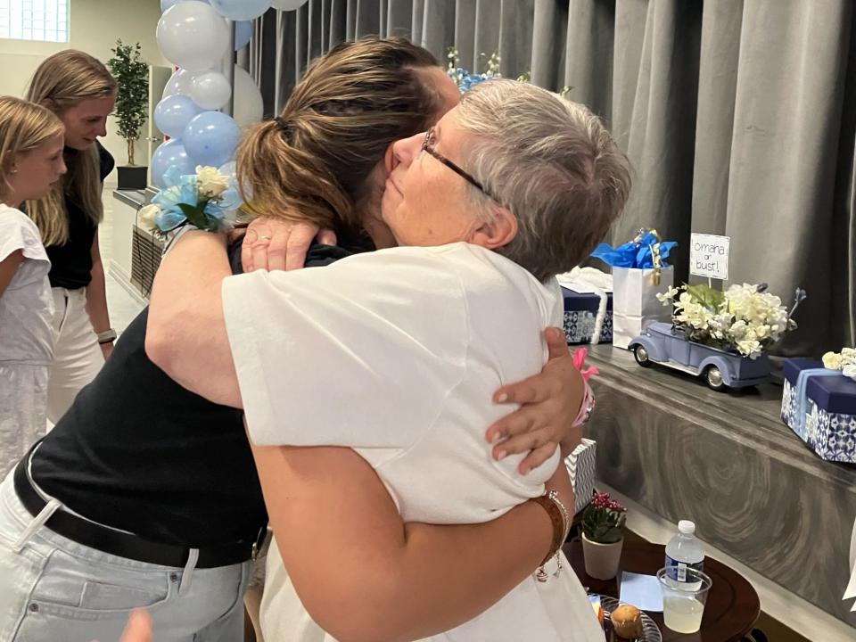 Sr. Kathy Avery, 80, hugs one of her former students, Sophia Weiksnar, 19,  at her farewell celebration on Sept. 24, 2023 at St. Clare of Montefalco Catholic School in Grosse Pointe Park. Avery, the former principal, is leaving St. Clare after 16 years of service. She is returning to the motherhouse in Omaha, Neb.