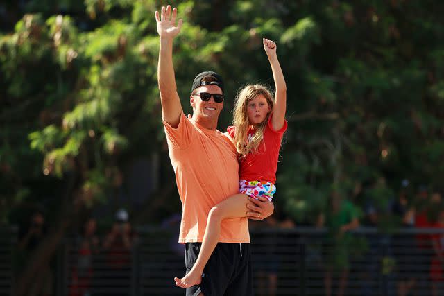 Mike Ehrmann/Getty Tom Brady celebrates with his daughter Vivian during the Tampa Bay Buccaneers Super Bowl boat parade in February 2021.