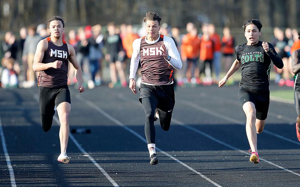 Mansfield Senior High School's Aaron Thompson, left, Keontez Bradley, center, and Clear Fork High School's Joe Stupka compete in the 100 dash at the Madison Track Invitational at Madison Comprehensive High School Thursday, March 30, 2023. TOM E. PUSKAR/ASHLAND TIMES-GAZETTE