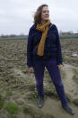 Biological engineer and environmentalist Ineke Maes stands in a field in West Flanders, Belgium, Wednesday, Feb. 21, 2024. The tire tracks of massive tractors, that left impenetrable puddles filled with green sludge, drew Maes to western Belgium's industrial farmlands. There she had hoped the EU's burgeoning environmental awareness would start to make a fundamental difference by improving exhausted soil. (AP Photo/Virginia Mayo)