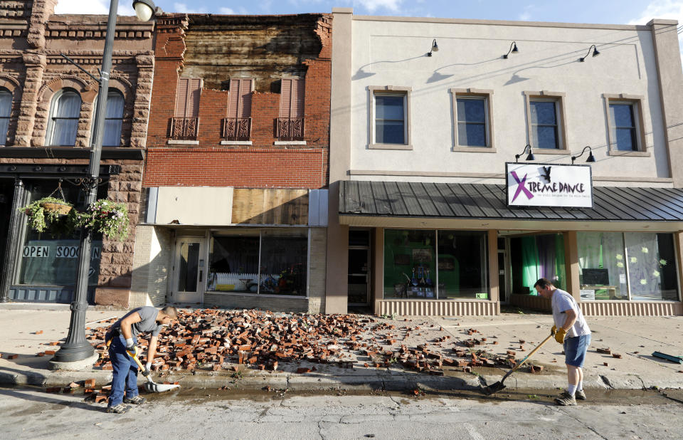 <p>Workers clean up bricks from a tornado-damaged business on Main Street, Thursday, July 19, 2018, in Marshalltown, Iowa. Several buildings were damaged by a tornado in the main business district in town including the historic courthouse. (Photo: Charlie Neibergall/AP) </p>