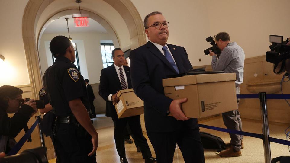 Lawyers and others arrive at New York State Supreme Court for the start of the civil fraud trial against former President Donald Trump on October 02, 2023 in New York City. Trump and his associates are being charged with inflating assets in fraudulent financial statements. A ruling last week by a judge determined that Trump and his co-defendants are liable for “persistent and repeated” fraud.