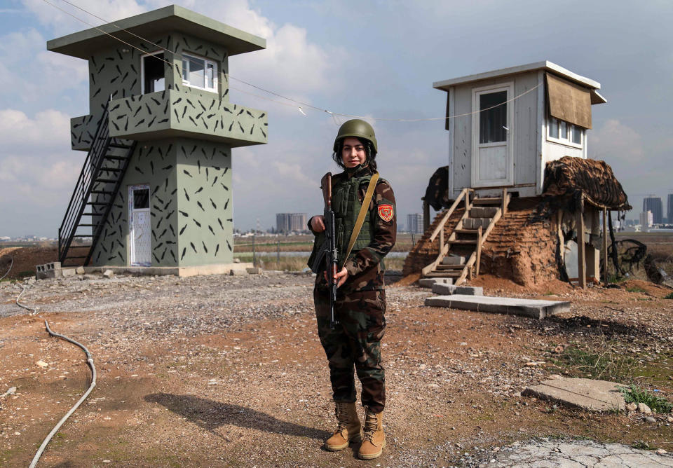 <p>Arazo Qadri, a 27-year-old female member of the Iraqi Kurdish Peshmerga, stands guard at the Peshmerga Military camp in Arbil, the capital of the Kurdish autonomous region in northern Iraq, on February 20, 2018. (Photo: Safin Hamed/AFP/Getty Images) </p>