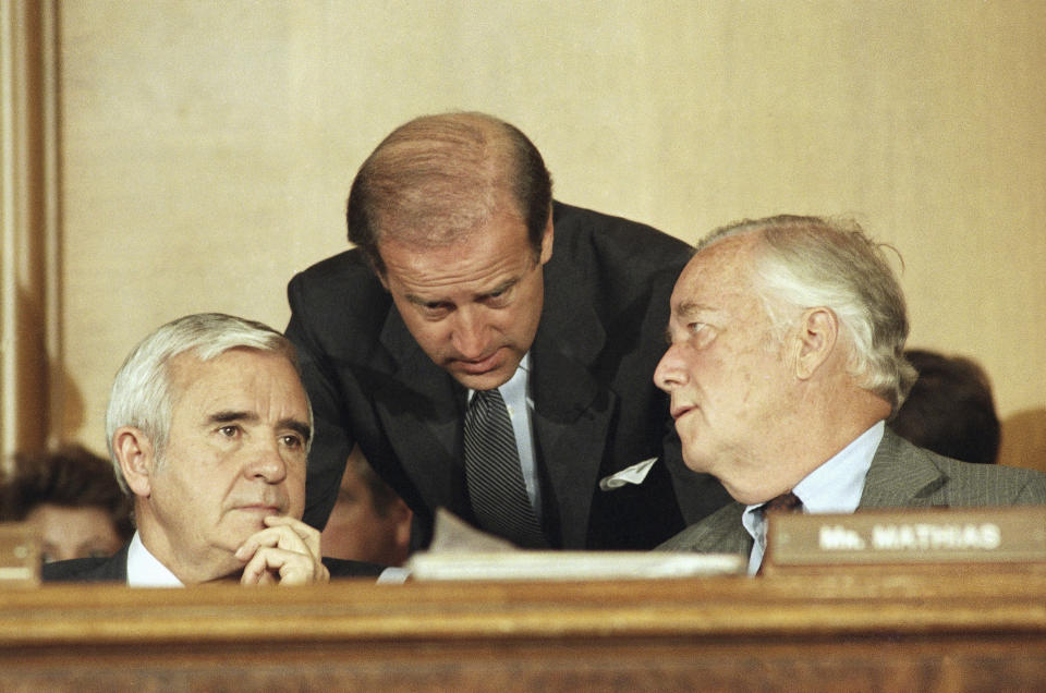 FILE - In this Aug. 14, 1986, file photo Senate Judiciary Committee members from left, Sen. Paul Laxalt, R-Nev., Sen. Joseph Biden, D-Del., and Sen. Charles McCurdy Mathias Jr., R-Md. confer prior to voting 13 to 5 in Washington on Capitol Hill in favor of President Ronald Reagan's nomination of William Rehnquist to be chief justice. (AP Photo/Lana Harris, File)