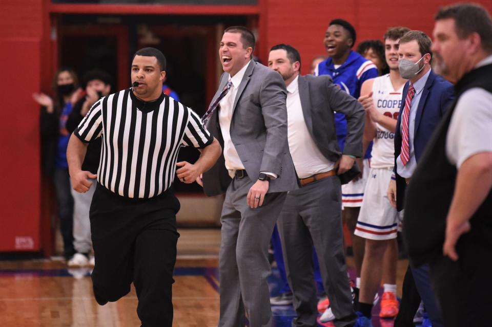 Cooper coach Bryan Conover reacts to Jalen Cherry's slam dunk at the end of Friday's Southtown Showdown against Wylie at Cougar Gym on Jan. 21, 2022. The Cougars led almost the entire game before pulling away late in the fourth quarter to win 54-41.