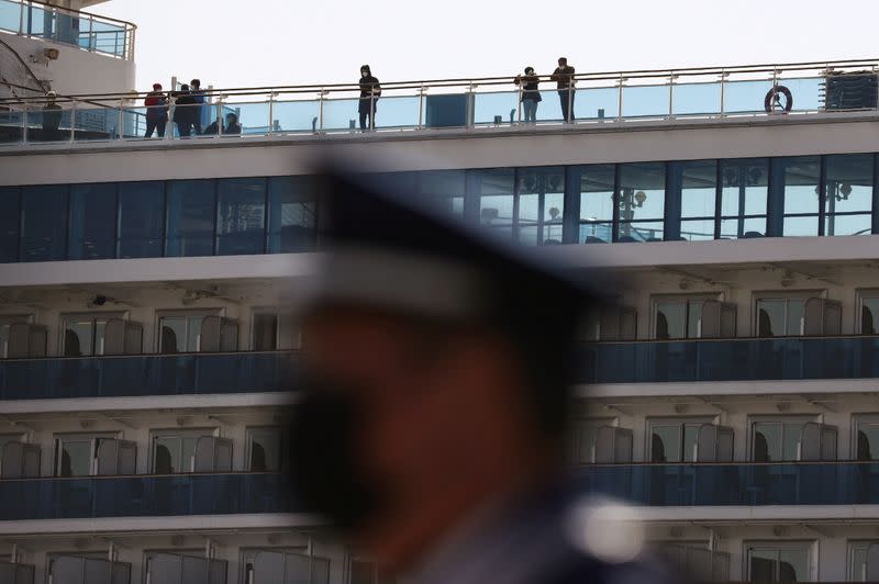 Passengers wearing masks are seen on cruise ship Diamond Princess at Daikoku Pier Cruise Terminal in Yokohama