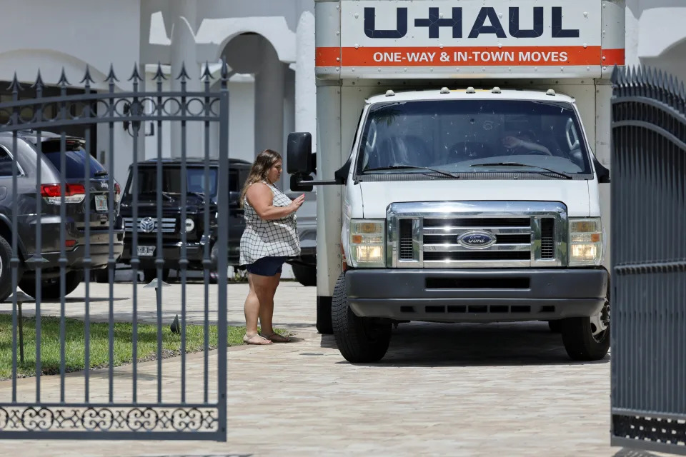 A woman leaves Sean Kingston's Southwest Ranches, Fla., home Thursday, May 23, 2024. Attorney Dennis Card said she was one of the owners of an $80,000 bed and had flown in from Utah to retrieve it. A SWAT team raided rapper Kingston's rented mansion on Thursday, and arrested his mother on fraud and theft charges that an attorney says stems partly from the installation of a massive TV at the home. (Amy Beth Bennett/South Florida Sun-Sentinel via AP)