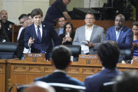Los Angeles councilmember Kevin De Leon, top left, addresses Los Angeles Dodgers baseball star Shohei Ohtani, sitting, bottom right, during a ceremony honoring Ohtani, Friday, May 17, 2024, in Los Angeles. (AP Photo/Damian Dovarganes)