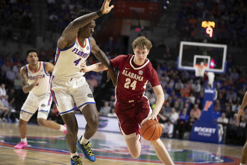 Alabama forward Sam Walters (24) drives against Florida forward Tyrese Samuel (4) during the second half of an NCAA college basketball game Tuesday, March 5, 2024, in Gainesville, Fla. (AP Photo/Alan Youngblood)