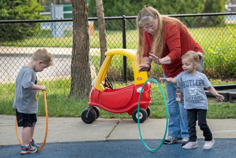 Robin Wood, twos teacher/ lead teacher at Carmel Clay Edu-Care, plays with kids on the playground Thursday, May 18, 2023 at Clay Middle School.  The district offers childcare for its employees.