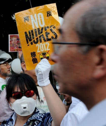 A protester displays a placard during an anti-nuclear protest in Tokyo on August 10. Japanese PM Yoshihiko Noda insists the country will go nuclear free as he rebutts criticism that his government is unable to come up with a coherent position on the issue