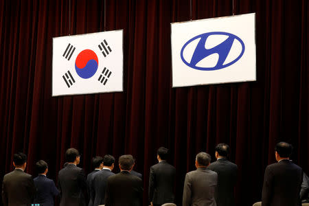 Board members of Hyundai Motor Group salute to a national flag during a general shareholders' meeting in Seoul, South Korea, March 22, 2019. REUTERS/Kim Hong-Ji