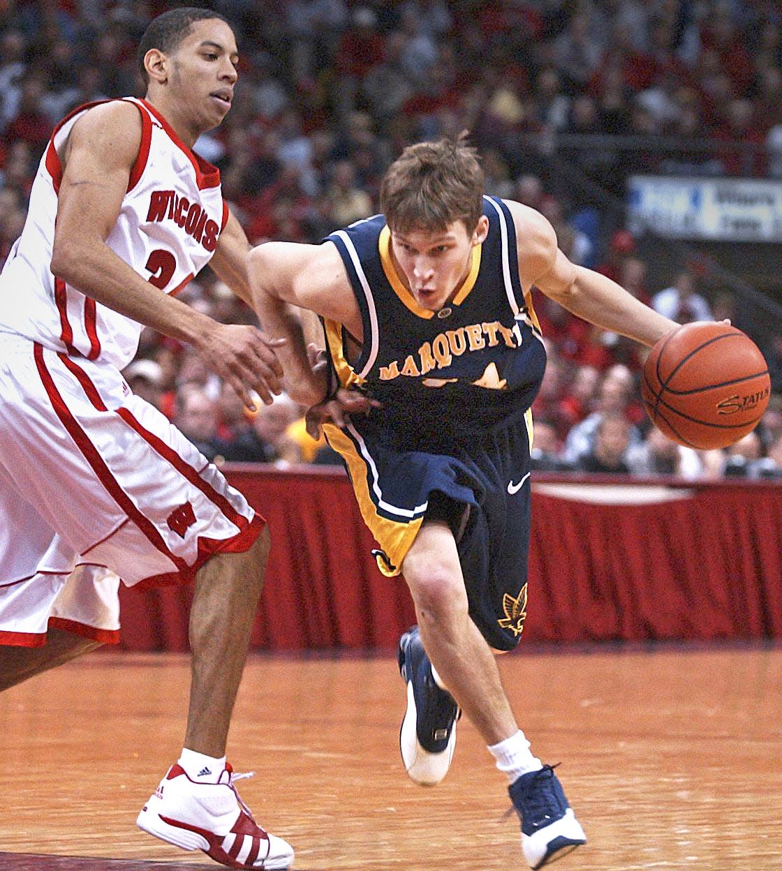Marquette's Travis Diener drives past Wisconsin's Devin Harris during a game from the Kohl Center in Madison in 2003.