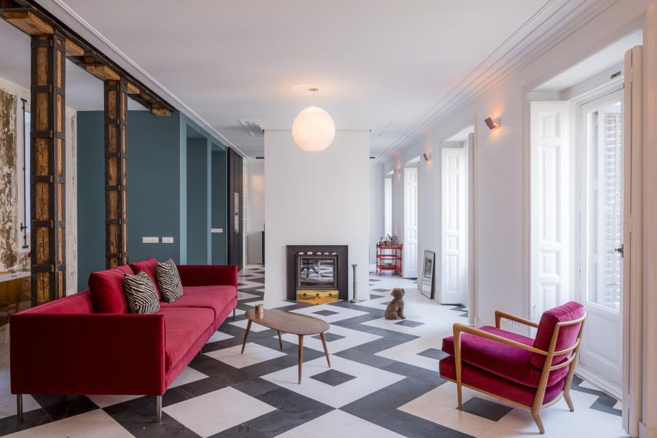 A living room with black and white flooring