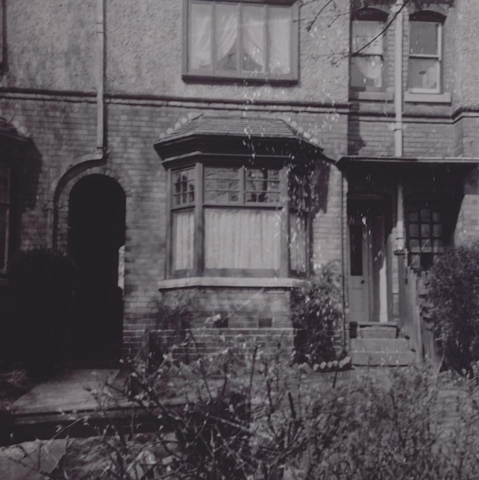 A black and white picture of an old abandoned home