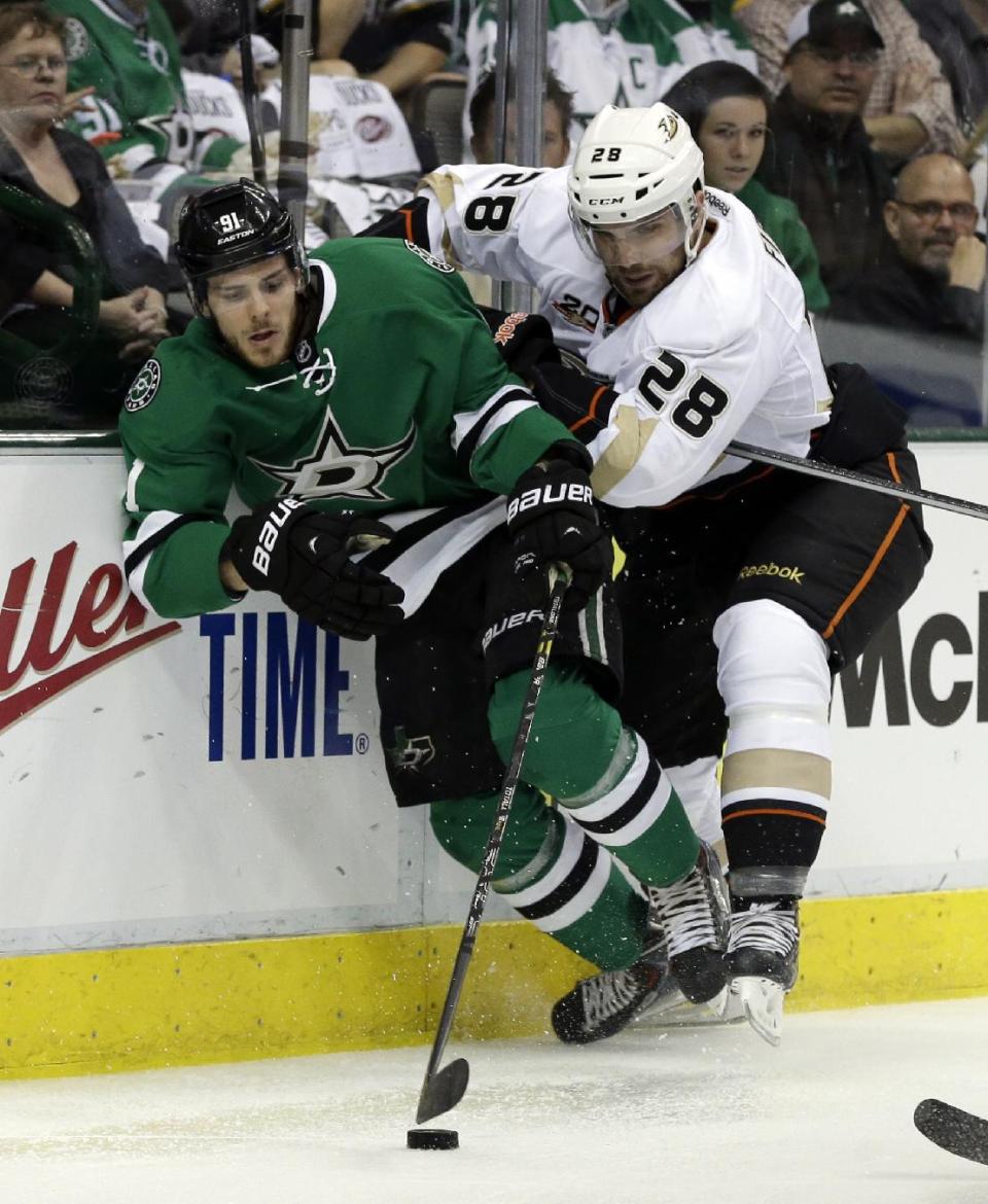 Dallas Stars' Tyler Seguin (91) fightys for control of the puck against Anaheim Ducks' Mark Fistric (28) in the first period of Game 4 a first-round NHL hockey Stanley Cup playoff series, Wednesday, April 23, 2014, in Dallas. (AP Photo/Tony Gutierrez)