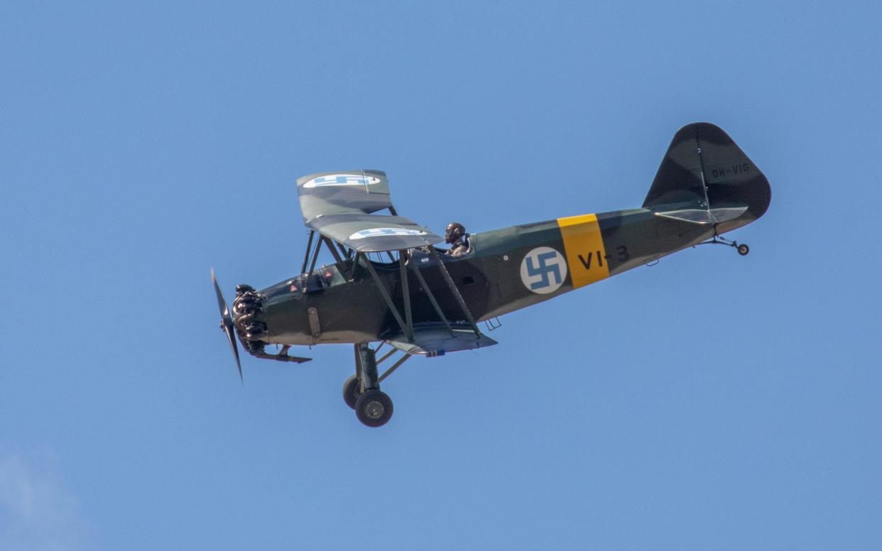 A vintage Finnish Air Force plane bearing a swastika flying at an air show in 2018 - Alamy Stock Photo