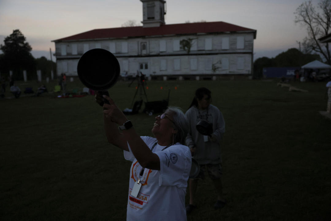 People bang pots and pans as part of a Choctaw Nation solar eclipse tradition