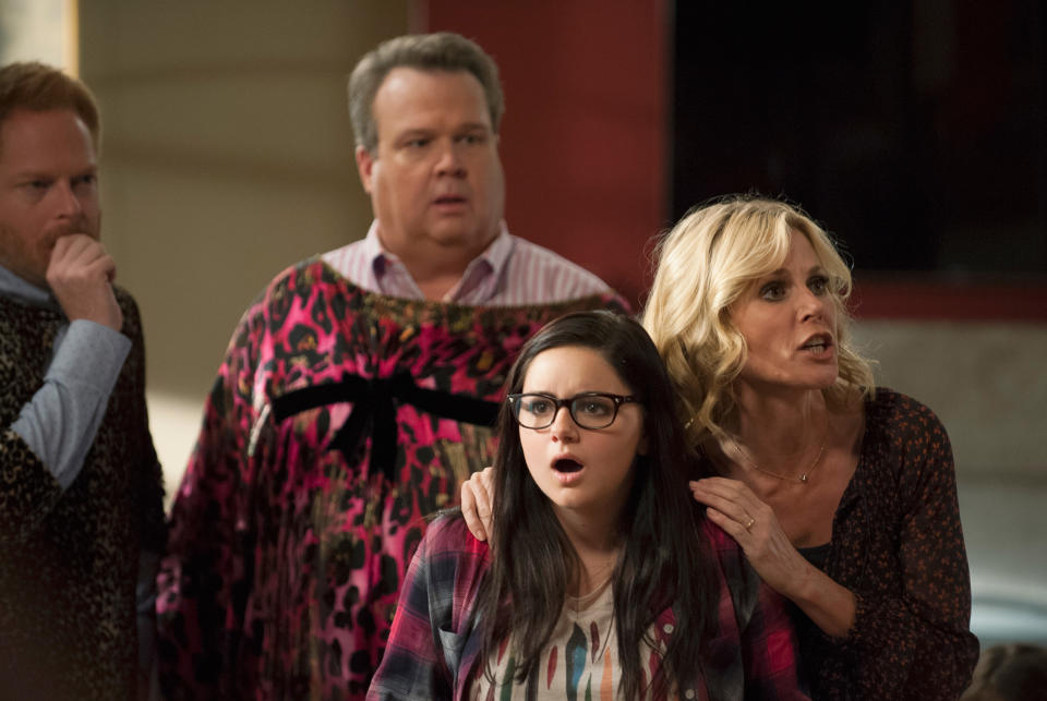 Three actors on set, a shocked young woman is center, flanked by concerned older man and woman. They're in a domestic scene