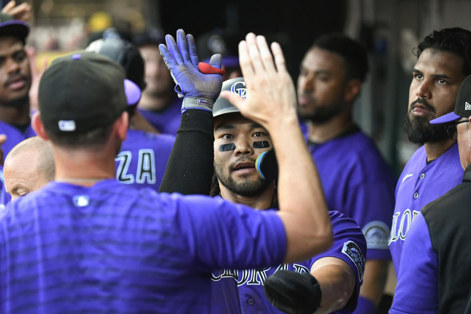 Colorado Rockies' Connor Joe celebrates with teammates after scoring against Minnesota Twins during the sixth inning of a baseball game Friday, June 24, 2022, in Minneapolis. The Rockies won 1-0. (AP Photo/Craig Lassig)