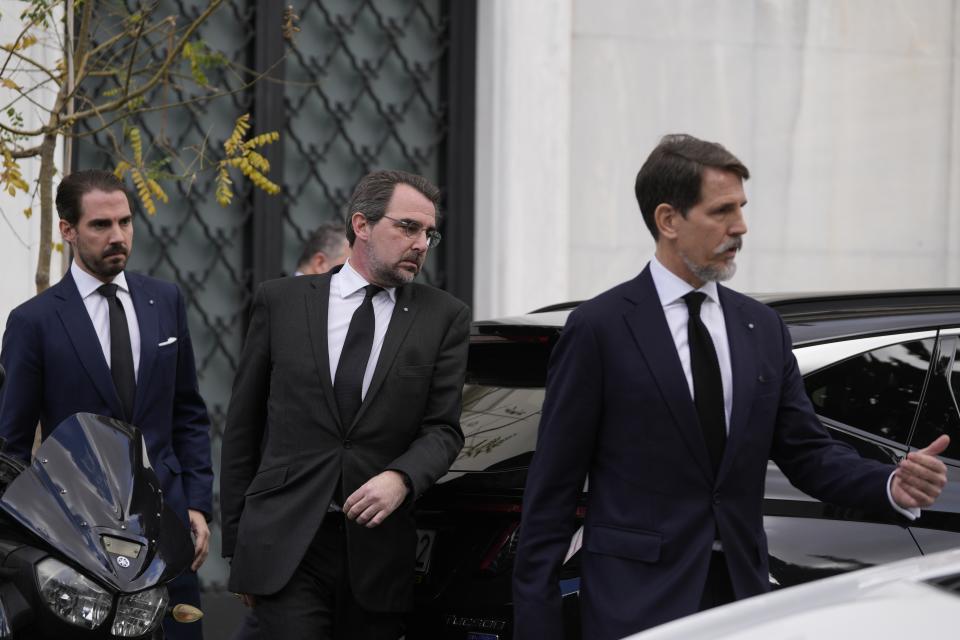 The sons of former king Constantine of Greece, Pavlos, right, Nikolaos, center, and Philippos leave Maximos mansion, the prime minister's office, in Athens, Greece, Wednesday, Jan. 11, 2023. Greece's government says Constantine, the former and last king of Greece, will be buried as a private citizen in Tatoi, the former summer residence of Greece's royals where his parents and ancestors are buried. A controversial figure in Greek history, Constantine died in hospital late Tuesday at the age of 82. (AP Photo/Thanassis Stavrakis)