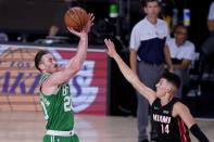 Boston Celtics' Gordon Hayward (20) attempts a shot as Miami Heat's Tyler Herro (14) defends during the second half of an NBA conference final playoff basketball game, Saturday, Sept. 19, 2020, in Lake Buena Vista, Fla. (AP Photo/Mark J. Terrill)