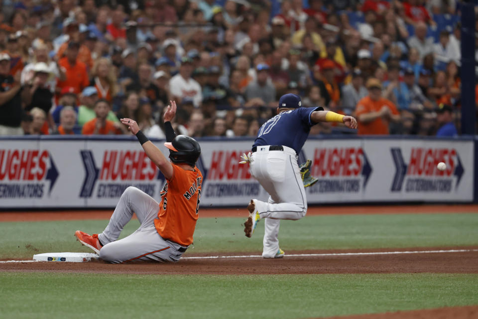 Baltimore Orioles' Ryan Mountcastle slides safely into third beating the throw to Tampa Bay Rays third baseman Isaac Paredes during the fourth inning of a baseball game Saturday, July 22, 2023, in St. Petersburg, Fla. (AP Photo/Scott Audette)