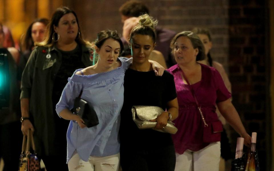 Police escort members of the public from the Manchester Arena - Credit: Getty