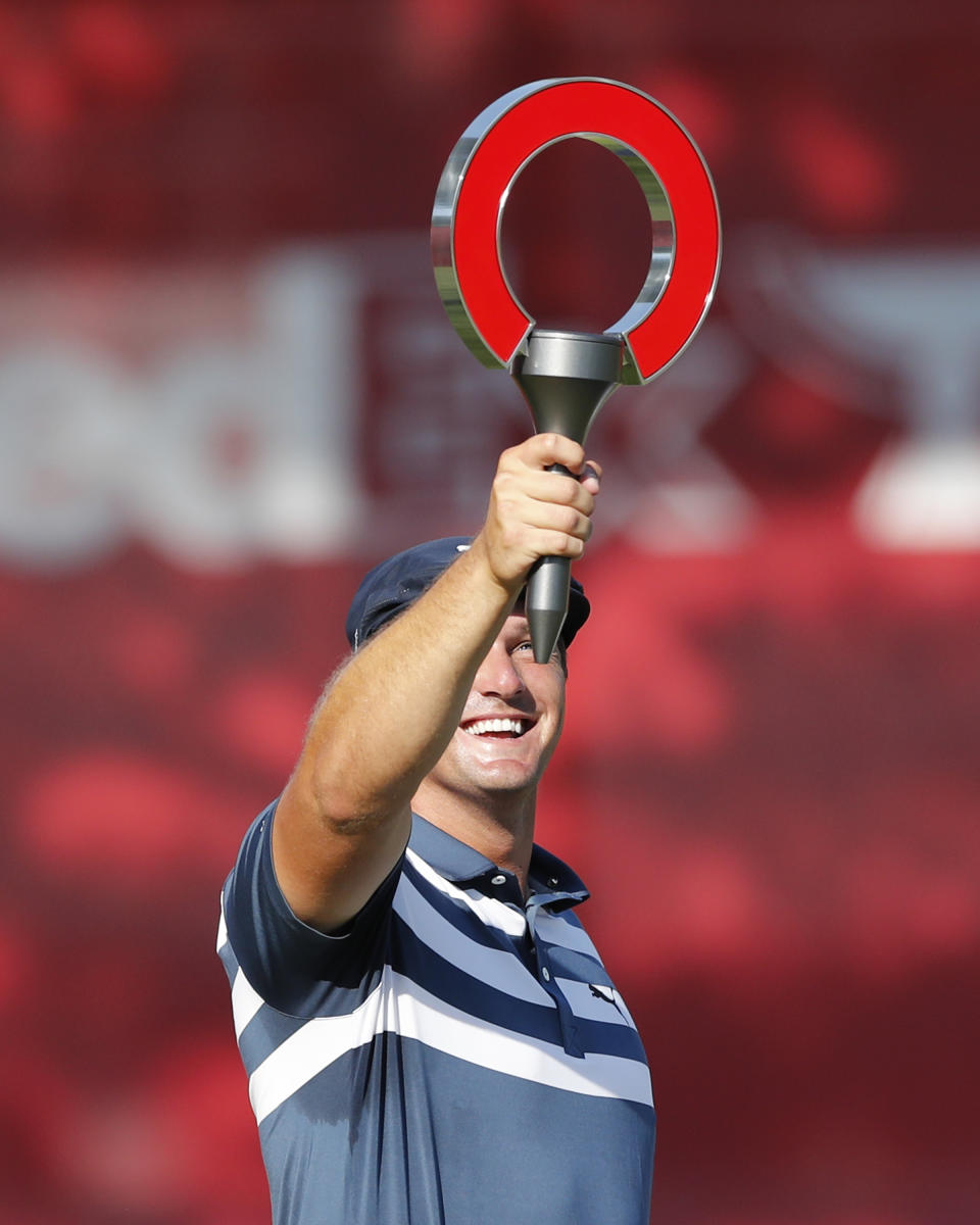 Bryson DeChambeau holds the Rocket Mortgage Classic golf tournament trophy Sunday, July 5, 2020, at Detroit Golf Club in Detroit. DeChambeau won the tournament. (AP Photo/Carlos Osorio)