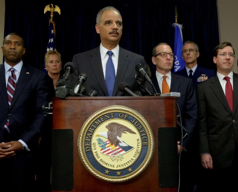 U.S. Attorney General Eric Holder, center, arrives at a press conference followed by Acting Associate Attorney General Tony West, far left, and lead by Assistant Attorney General for the Criminal Division Lanny A. Breuer, top right, to speak about the 2010 Gulf Oil Spill settlement and criminal penalties in New Orleans, La. Thursday, Nov. 15, 2012. Holder said the settlement and indictments aren't the end of federal authorities' efforts and that the criminal investigation is continuing. Holder says much of the money BP has agreed to pay will be used to restore the environment in the Gulf. (AP Photo/Matthew Hinton)