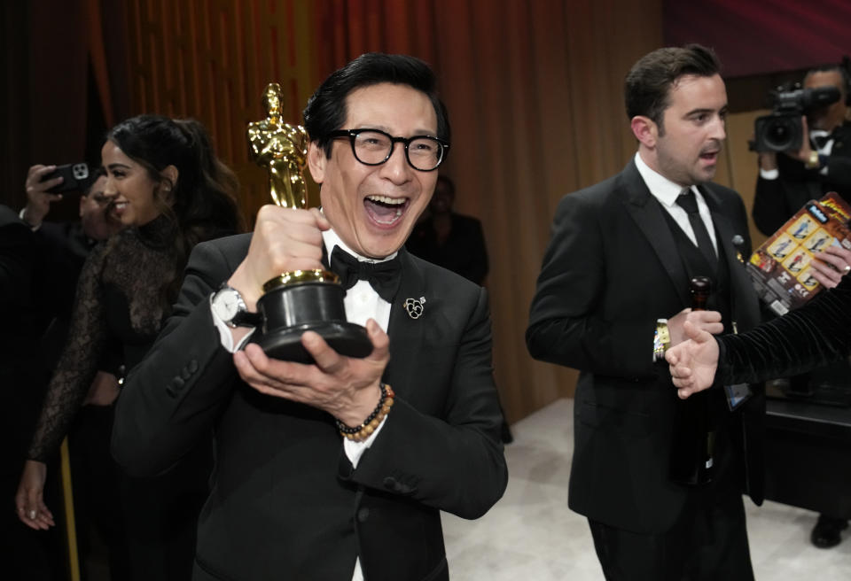 Ke Huy Quan poses with his award for best performance by an actor in a supporting role for "Everything Everywhere All at Once" at the Governors Ball after the Oscars on Sunday, March 12, 2023, at the Dolby Theatre in Los Angeles. (AP Photo/John Locher)