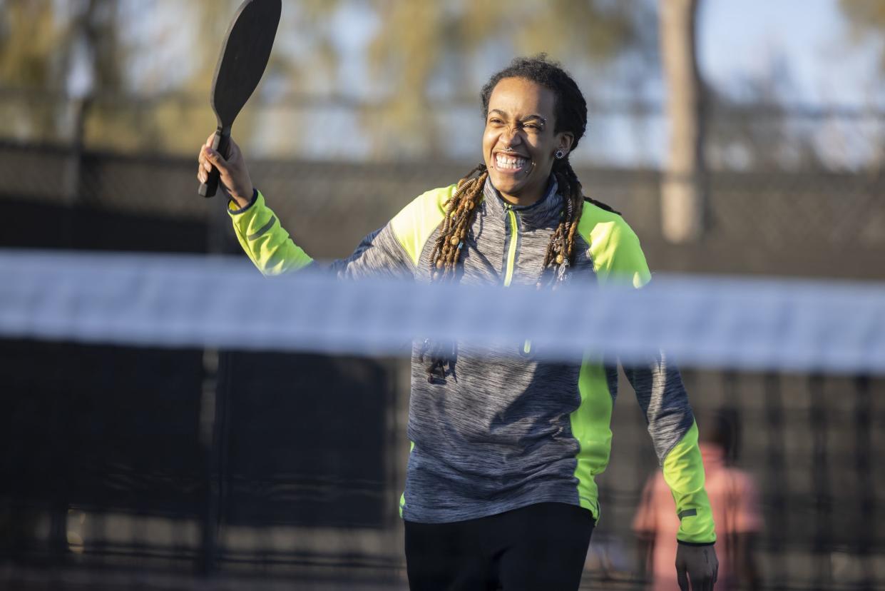 Playing Pickleball on a blue pickle ball court