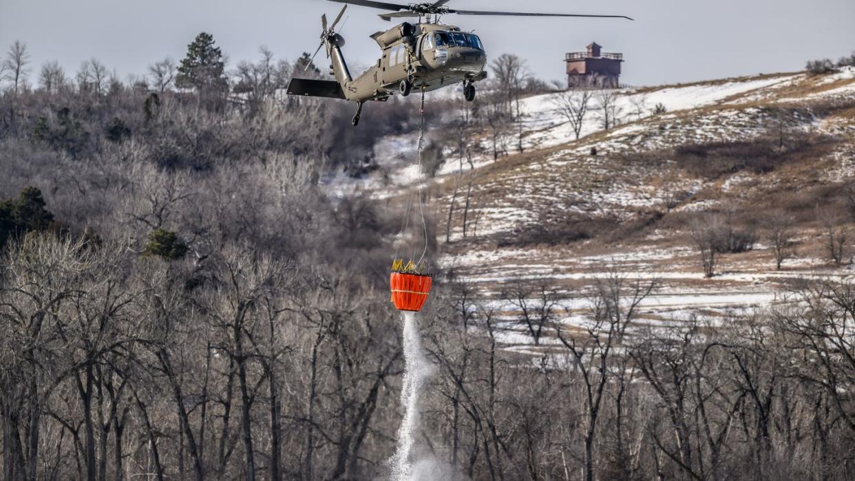 a north dakota national guard uh 60 black hawk helicopter drops 660 gallons of water from a bambi bucket onto an ice jam on the missouri river in bismarck, north dakota, feb 29, 2024, to break up the ice and prevent flooding over 70,000 gallons of water were dropped in 4 hours us national guard photo by staff sgt samuel kroll, north dakota national guard public affairs office