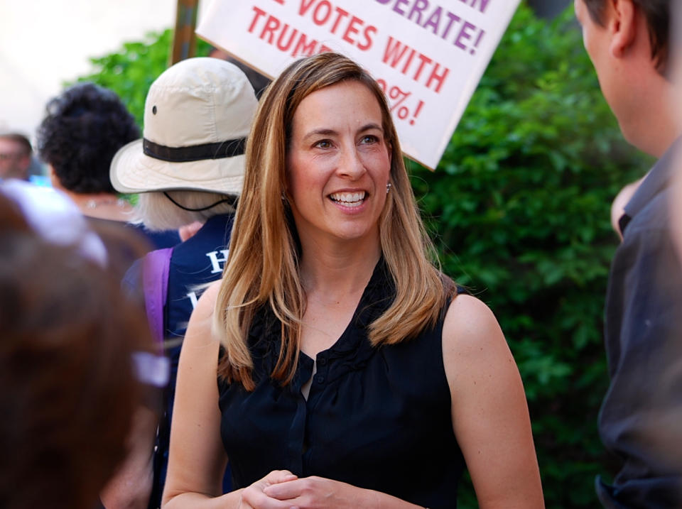 FILE- In this May 19, 2017, file photo, Mikie Sherrill joins protesters with NJ 11th for Change outside of U.S. Rep. Rodney Frelinghuysen's Morristown office. Sherrill, a former Navy helicopter pilot and federal prosecutor, is looking to capture a GOP congressional seat in New Jersey. Sherrill is one of some 200 women who have won their primaries for U.S. House, with 94 of these candidates surviving crowded fields with three or more candidates, according to an analysis of election results. (Justin Zaremba/NJ Advance Media via AP, File)