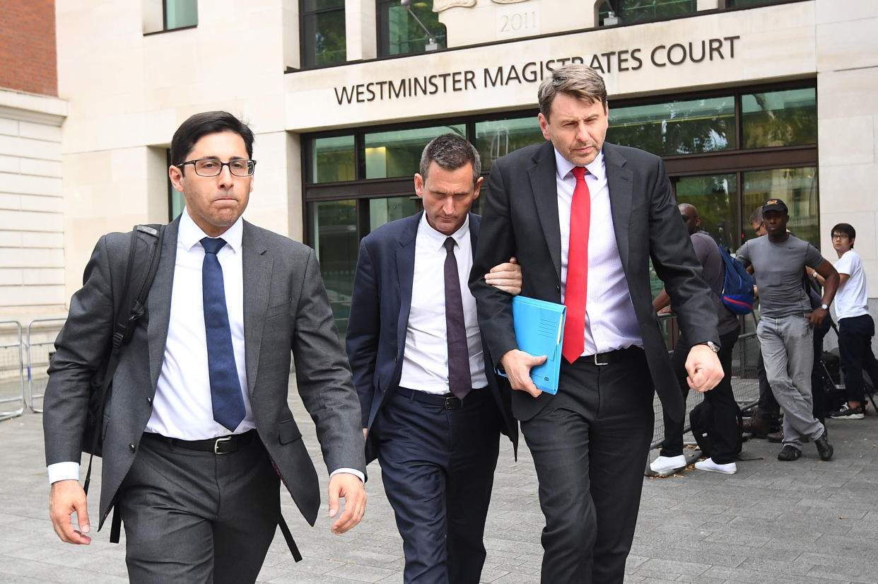 Lord Holmes of Richmond (centre) leaves Westminster Magistrates' Court, London where he appeared on charges of sexual assault.